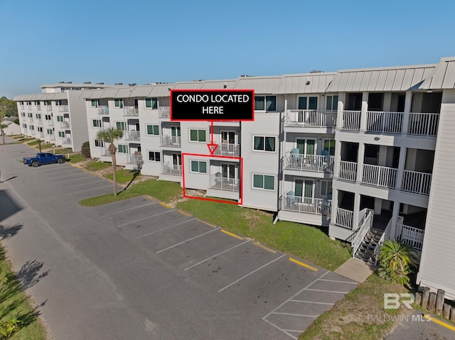 view of building exterior featuring uncovered parking