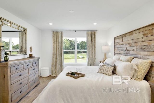 bedroom with light wood-style flooring, multiple windows, and recessed lighting