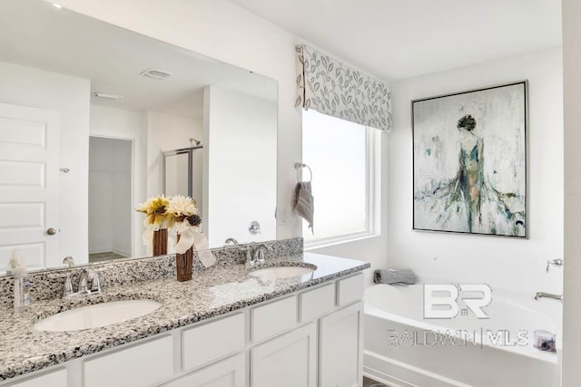 full bathroom featuring a bath, double vanity, and a stall shower
