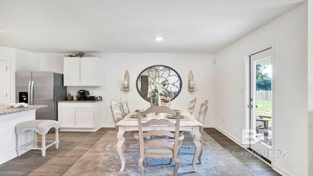 dining area with dark wood finished floors, baseboards, and recessed lighting