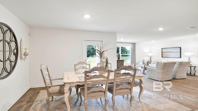 dining room with wood finished floors, recessed lighting, and baseboards