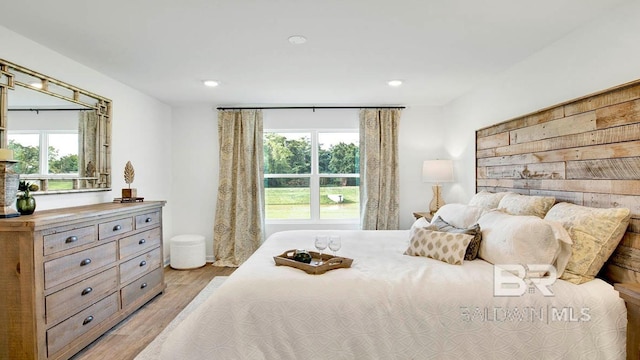 bedroom featuring light wood-style flooring, multiple windows, and recessed lighting