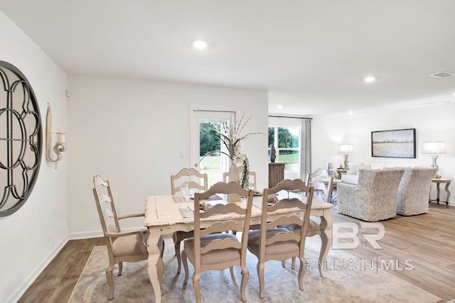 dining area with hardwood / wood-style flooring