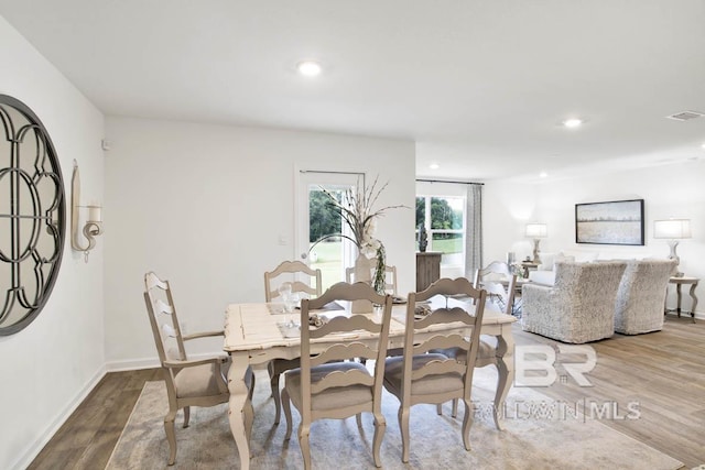 dining space with wood finished floors, recessed lighting, and baseboards