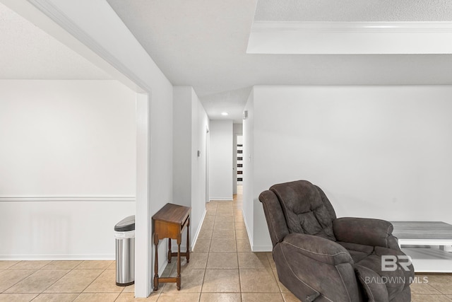 interior space with light tile patterned floors and a textured ceiling