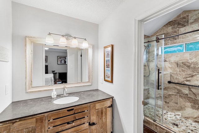 bathroom with vanity, lofted ceiling, walk in shower, and a textured ceiling