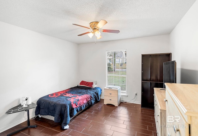 bedroom featuring a textured ceiling, ceiling fan, and dark hardwood / wood-style floors