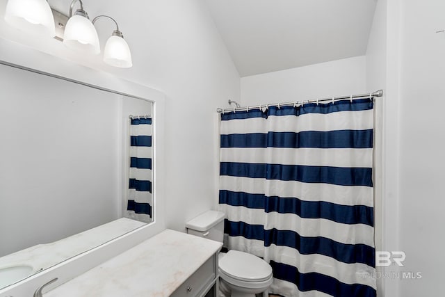 bathroom featuring vanity, toilet, and a shower with shower curtain