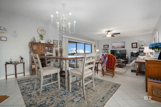 dining space featuring ceiling fan with notable chandelier and light tile patterned flooring