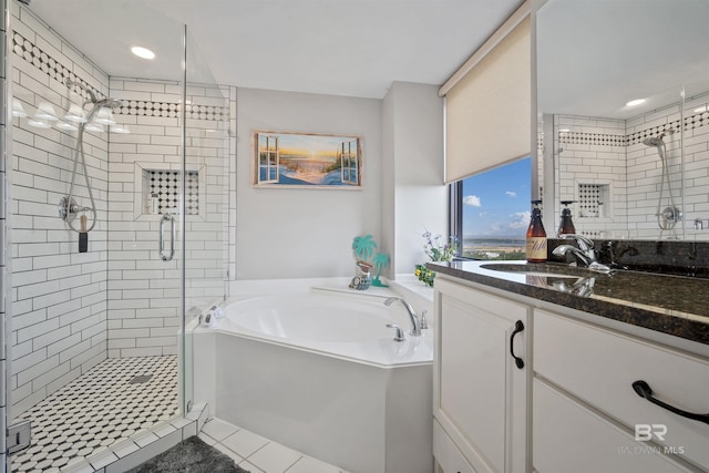 full bath featuring a shower stall, recessed lighting, vanity, and a garden tub