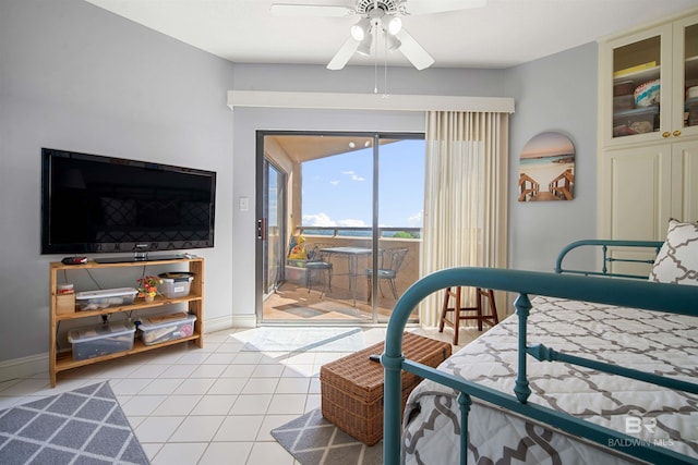 bedroom featuring access to exterior, ceiling fan, light tile patterned flooring, and baseboards