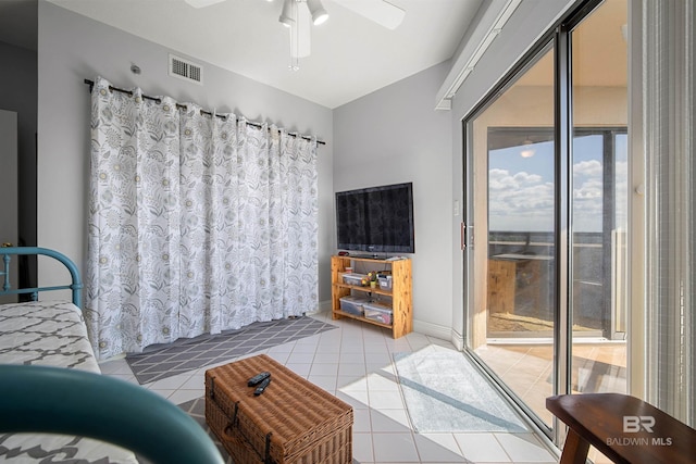 tiled living room with visible vents, a ceiling fan, and a healthy amount of sunlight