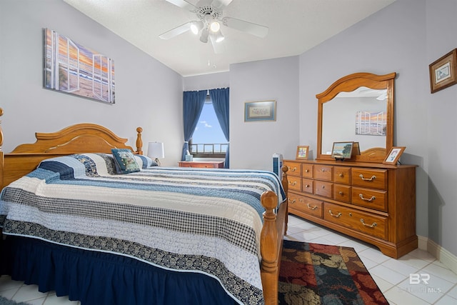 bedroom featuring light tile patterned floors, baseboards, and ceiling fan