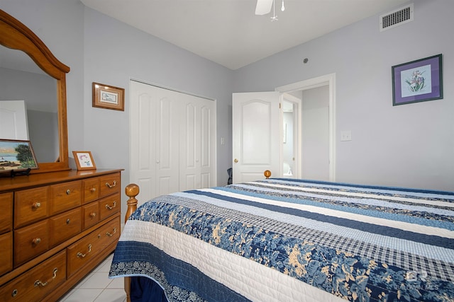 bedroom featuring visible vents, a closet, a ceiling fan, and light tile patterned flooring