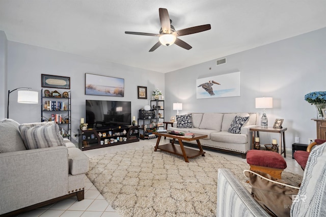 living area featuring light tile patterned floors, visible vents, and a ceiling fan
