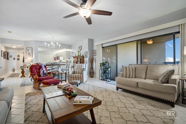 living area with ceiling fan with notable chandelier and light tile patterned flooring