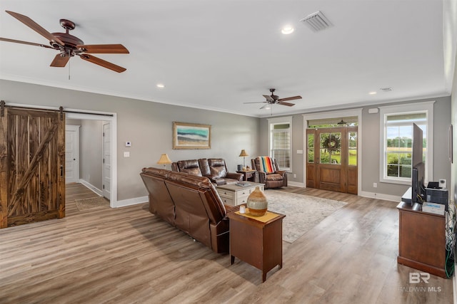 20011 Lawrence Rd, Fairhope, AL 36532 - living area featuring a ceiling fan, crown molding, baseboards, a barn door, and light wood finished floors