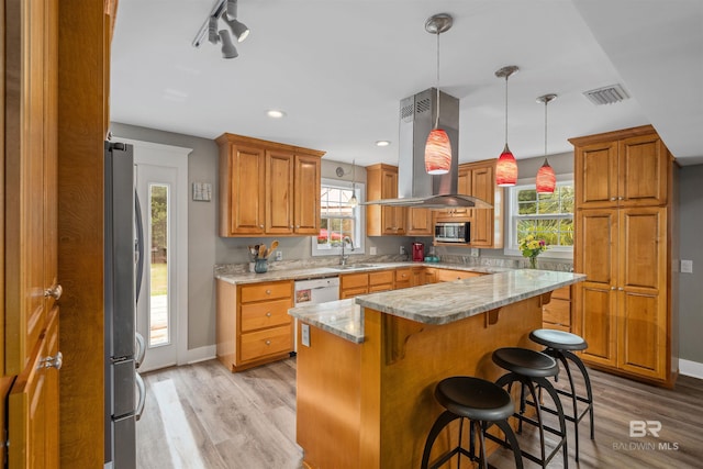 20011 Lawrence Rd, Fairhope, AL 36532 - kitchen featuring stainless steel appliances, island range hood, a sink, light wood-type flooring, and baseboards