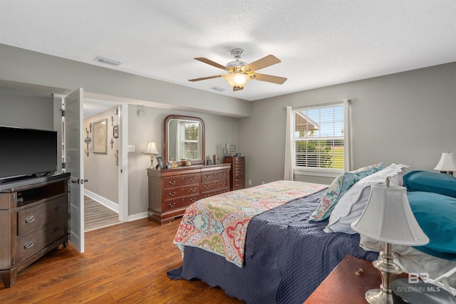 20011 Lawrence Rd, Fairhope, AL 36532 - bedroom with wood-type flooring, baseboards, ceiling fan, and a textured ceiling