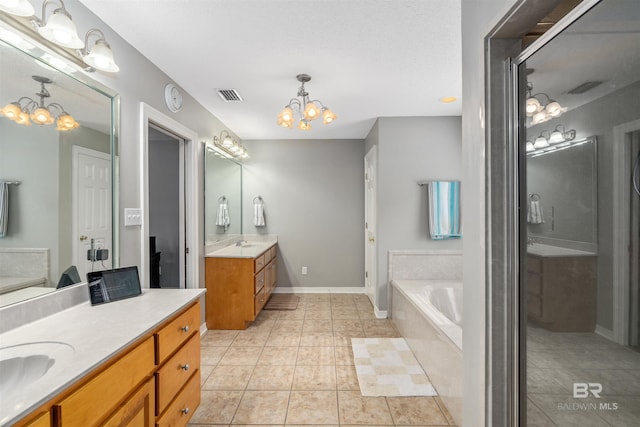 20011 Lawrence Rd, Fairhope, AL 36532 - full bath featuring a chandelier, two vanities, a garden tub, tile patterned floors, and baseboards