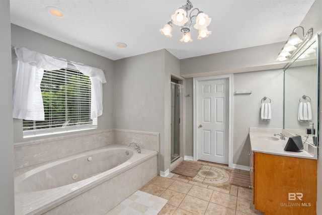20011 Lawrence Rd, Fairhope, AL 36532 - bathroom featuring a tub with jets, vanity, a stall shower, tile patterned flooring, and a chandelier