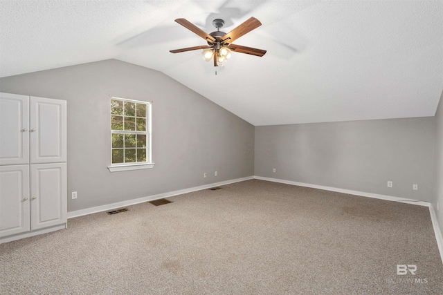 20011 Lawrence Rd, Fairhope, AL 36532 - bonus room featuring vaulted ceiling, a ceiling fan, light colored carpet, baseboards, and a textured ceiling