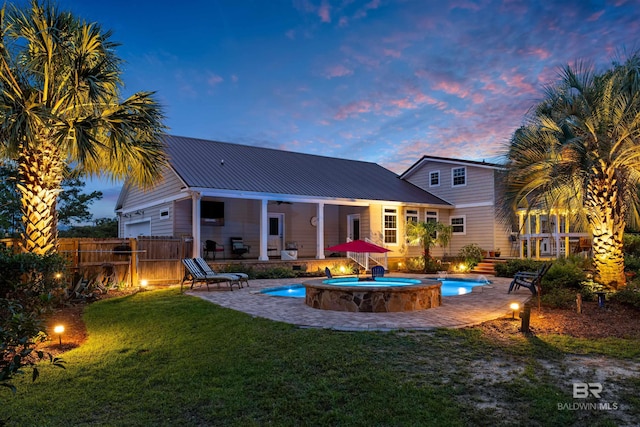 20011 Lawrence Rd, Fairhope, AL 36532 - rear view of property featuring a patio area, metal roof, and an in-ground hot tub