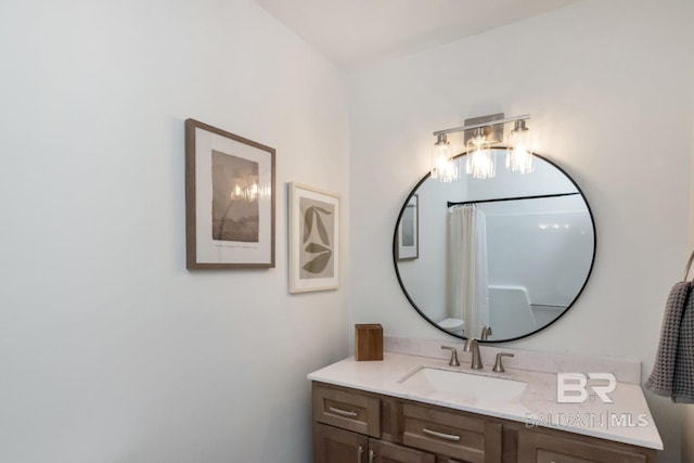 bathroom featuring walk in shower and vanity