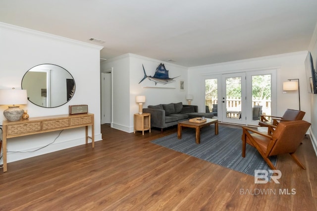 living room featuring dark wood-type flooring and ornamental molding