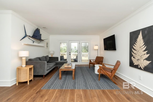 living room featuring crown molding and wood-type flooring