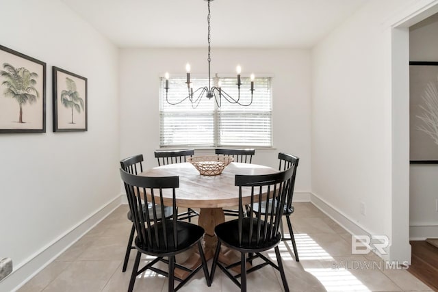 tiled dining room featuring a chandelier