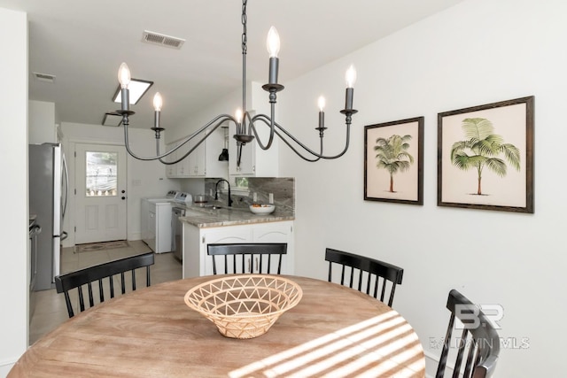 dining room featuring sink and washer and dryer