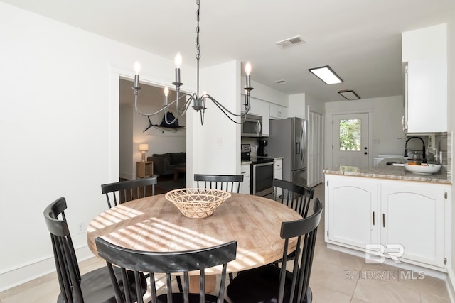 dining space with sink and light tile patterned floors