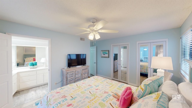 bedroom with multiple windows, ceiling fan, light hardwood / wood-style flooring, and a textured ceiling