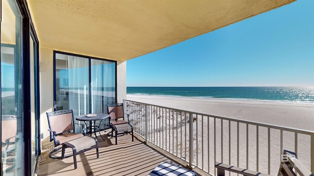 balcony with a beach view and a water view