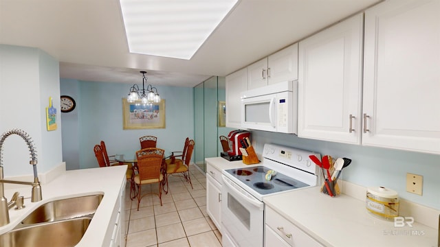 kitchen with sink, an inviting chandelier, pendant lighting, white appliances, and white cabinets