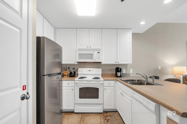 kitchen with white appliances, a sink, white cabinetry, recessed lighting, and light countertops