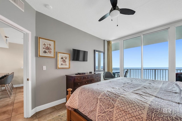 bedroom with light tile patterned floors, baseboards, access to outside, floor to ceiling windows, and ceiling fan