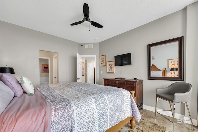 tiled bedroom with baseboards and ceiling fan