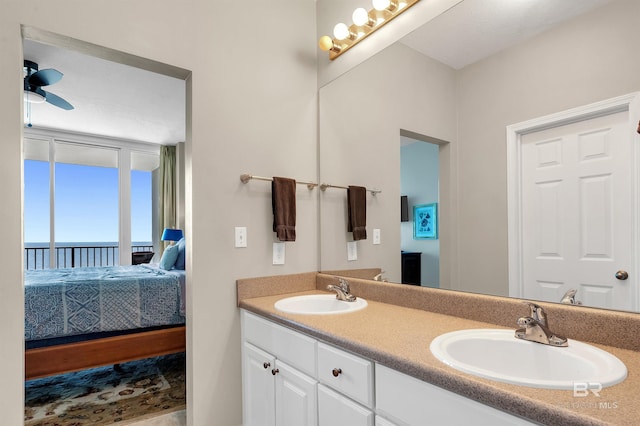 ensuite bathroom featuring double vanity and a water view
