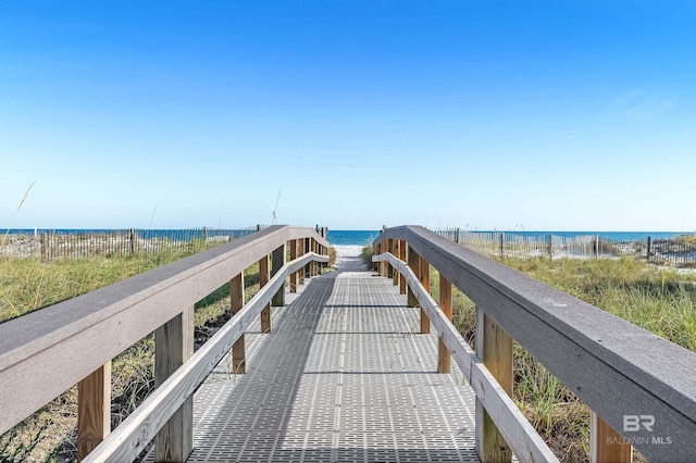 view of home's community with view of water and beach