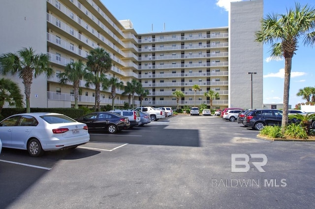 view of building exterior with uncovered parking