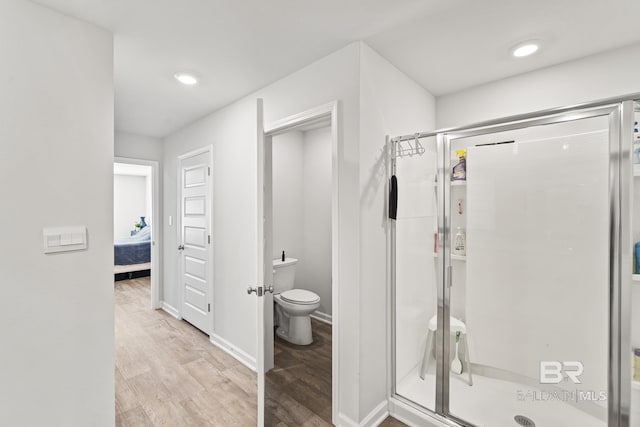 full bathroom featuring recessed lighting, toilet, a shower stall, ensuite bath, and wood finished floors