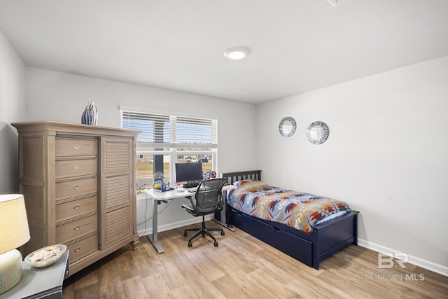 bedroom with wood finished floors and baseboards