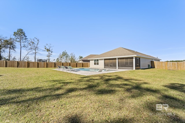 exterior space with a patio area, a sunroom, a fenced backyard, and a lawn