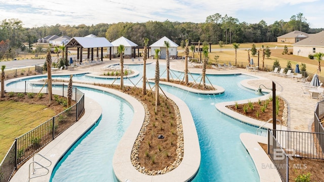 pool with a gazebo, a patio area, and fence