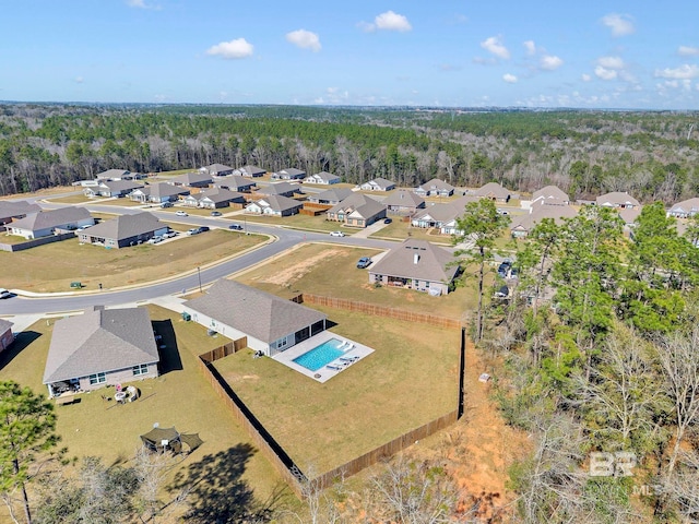 birds eye view of property featuring a forest view and a residential view