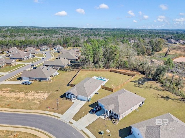 drone / aerial view with a forest view and a residential view