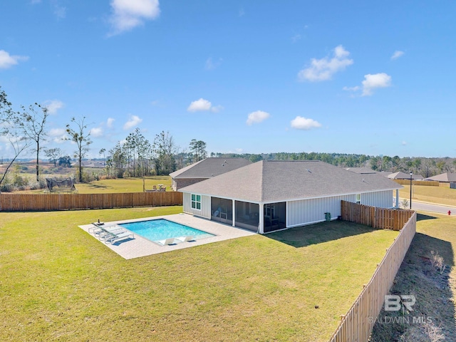 view of swimming pool featuring a lawn, a patio area, a fenced backyard, and a sunroom