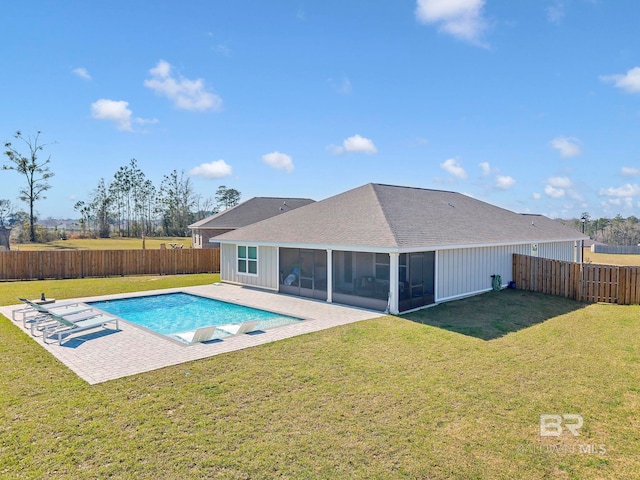 view of pool with a fenced backyard, a sunroom, a yard, a fenced in pool, and a patio area